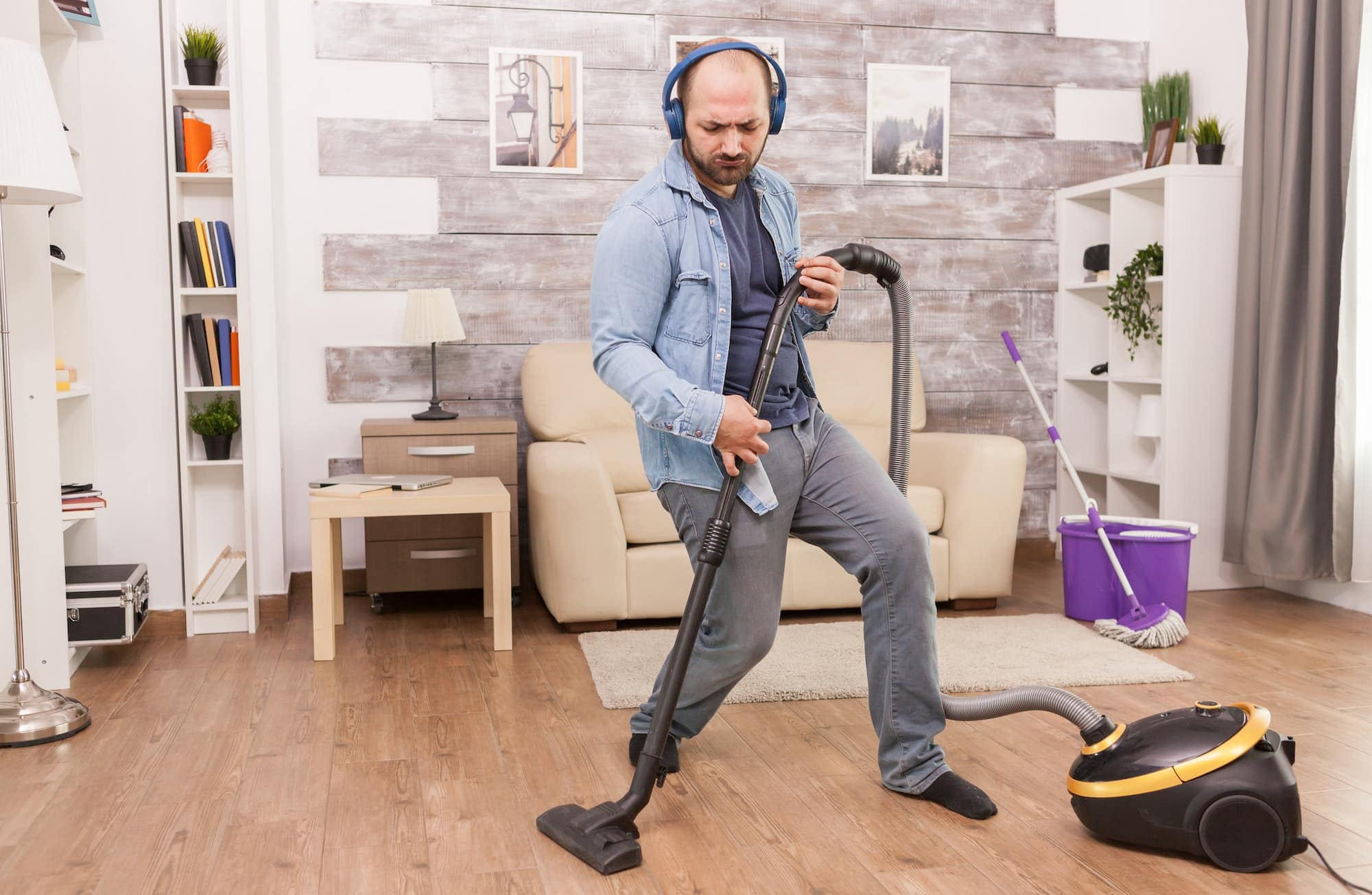 Excited man cleaning house