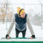 Young Man Living an Active Life with Headphones in Wintertime Gymnastics and Athletics